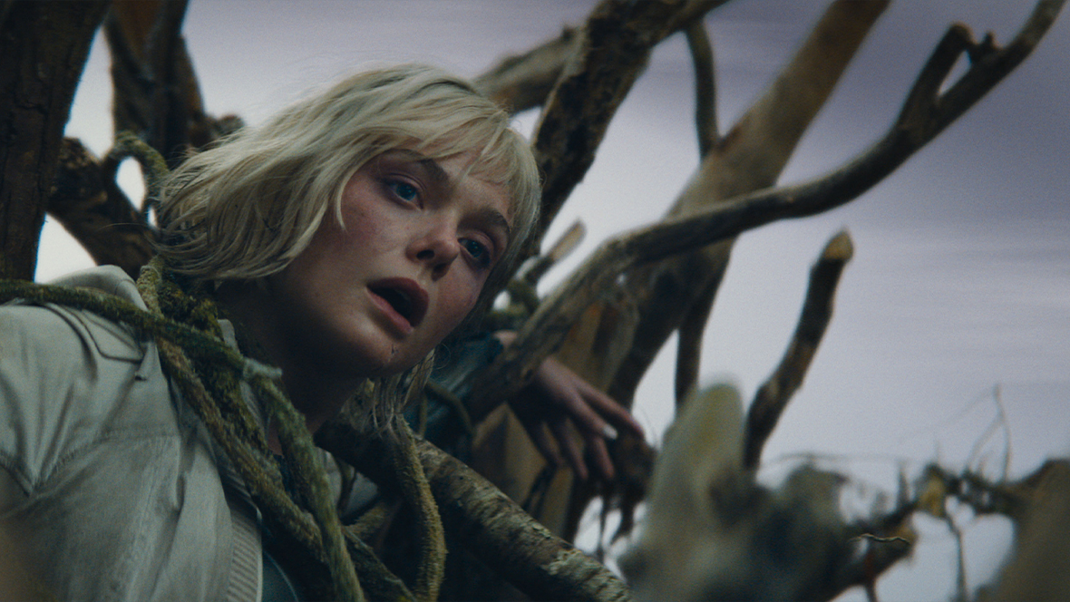 Thia, played by Elle Fanning, is trapped in a nest in a scene from 20th Century Studios' Predator: Badlands.