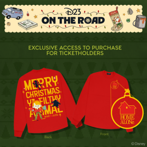 A promotional image featuring an exclusive Home Alone-inspired Spirit Jersey for D23 On the Road: Home Alone. The Spirit Jersey is a red long-sleeve sweater, on the back reads &ldquo;Merry Christmas, You Filthy Animal&rdquo; in large yellow text with stylized images of Kevin and the Wet Bandits. On the front, a small yellow Home Alone logo near the right shoulder.