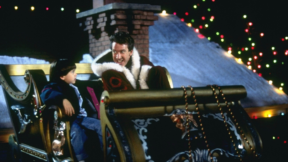Scott Calvin as Santa Clause (played by Disney Legend Tim Allen) and Charlie Calvin (played by Eric Lloyd) in a sleigh in The Santa Clause.