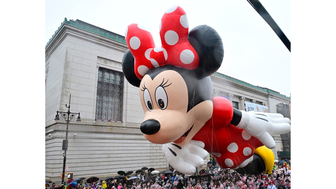 An image of the current Minnie Mouse balloon as seen in the Macy’s Thanksgiving Day Parade. She is wearing her iconic red and white polka dot dress, with a red and white polka dot bow in her hair and yellow shoes.