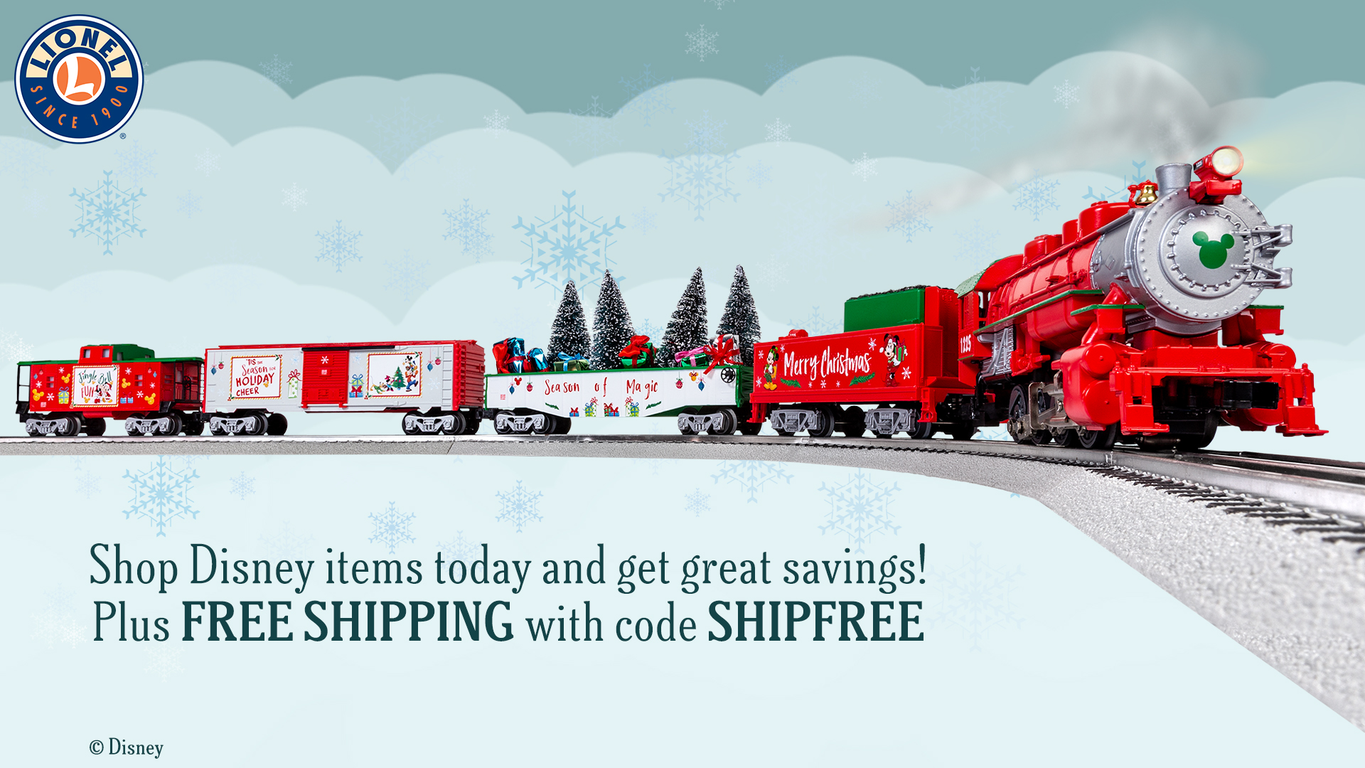 An image of a small red-and-white model train races down the tracks in a winter wonderland. The train is carrying Christmas accessories including trees and gifts. The front of the train is stamped with the Mickey Mouse logo. The copy below the train reads: “Shop Disney items today and get great savings! Plus FREE SHIPPING with code SHIPFREE. ©Disney.” On the top left of the image is the Lionel logo.