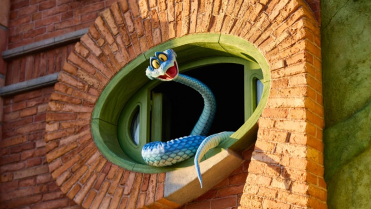Gary De'Snake debuts at Shanghai Disney Resort by slithering out of the brick wall.