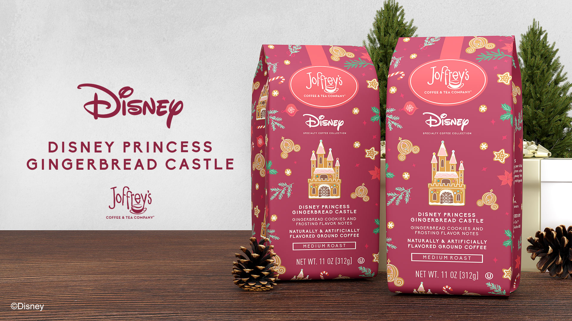 Two red Joffrey’s Coffee & Tea Company bags are placed in front of a Christmas setting with small trees and acorns. The coffee on display is themed to the Disney Princess Gingerbread Castle. The description reads “Gingerbread Cookies and Frosting Flavor Notes. Naturally & Artificially Flavored Ground Coffee. Medium Roast. Net WT. 11 OZ [312g],” along with an artist’s rendering of the Disneyland Castle as a gingerbread house. To the left is the Disney logo and the Joffrey’s Coffee & Tea Company logo. Between these logos is copy that reads “Disney Princess Gingerbread Castle.”
