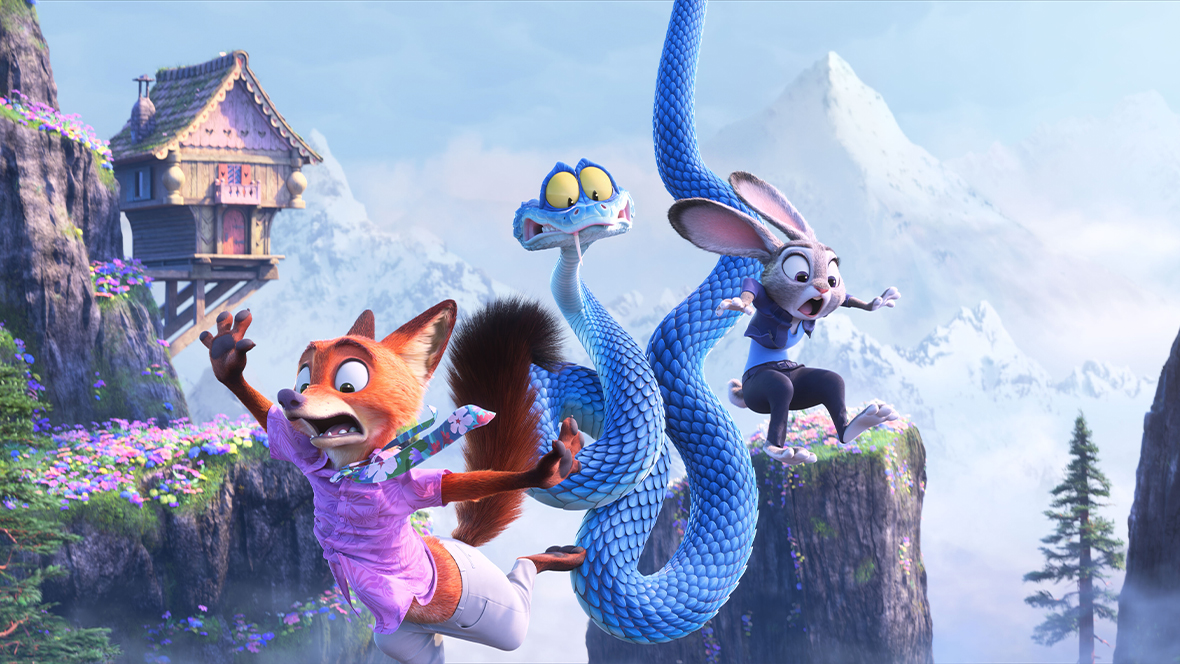 In a still from Walt Disney Animation Studios’ Zootopia 2, from left to right, Nick Wilde (voiced by Jason Bateman), Gary De’Snake (voiced by Ke Huy Quan), and Judy Hopps (voiced by Ginnifer Goodwin) are seen falling between several tree- and flower-covered mountains. A hilltop house is seen to their left. They have scared looks on their faces.