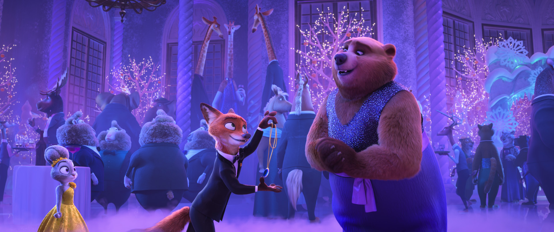 In an image from Walt Disney Animation Studios’ Zootopia 2, from left to right, Judy Hopps (voiced by Ginnifer Goodwin), Nick Wilde (voiced by Jason Bateman), and the Bearoness (voiced by Yvette Nicole Brown) are seen at the Zootennial gala. They are all wearing formal wear, and other fancy-dressed attendees are seen behind them.