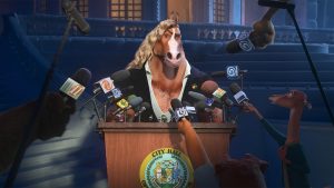 A still from Walt Disney Animation Studios&rsquo; Zootopia 2 features Mayor Brian Winddancer (voiced by Patrick Warburton); he&rsquo;s standing at a podium during what appears to be a press briefing. Unseen reporters are holding microphones towards him.
