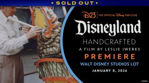 A promotional image for D23’s Disneyland Handcrafted World Premiere event at the Walt Disney Studios Lot on January 20, 2026. The left half of the image features a still from Leslie Iwerks’ upcoming documentary film Disneyland Handcrafted, in which a man in work uniform adds details to an ornate gold, orange, and yellow facade. The rest of the event details are on a black background on the right half of the image. A banner at the top reads SOLD OUT.