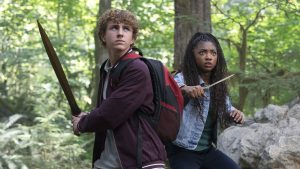 Percy Jackson, played by Walker Scobell, wields a sword, while Annabeth Chase, played by Leah Sava Jeffries, wields a dagger, in Disney's Percy Jackson and the Olympians.