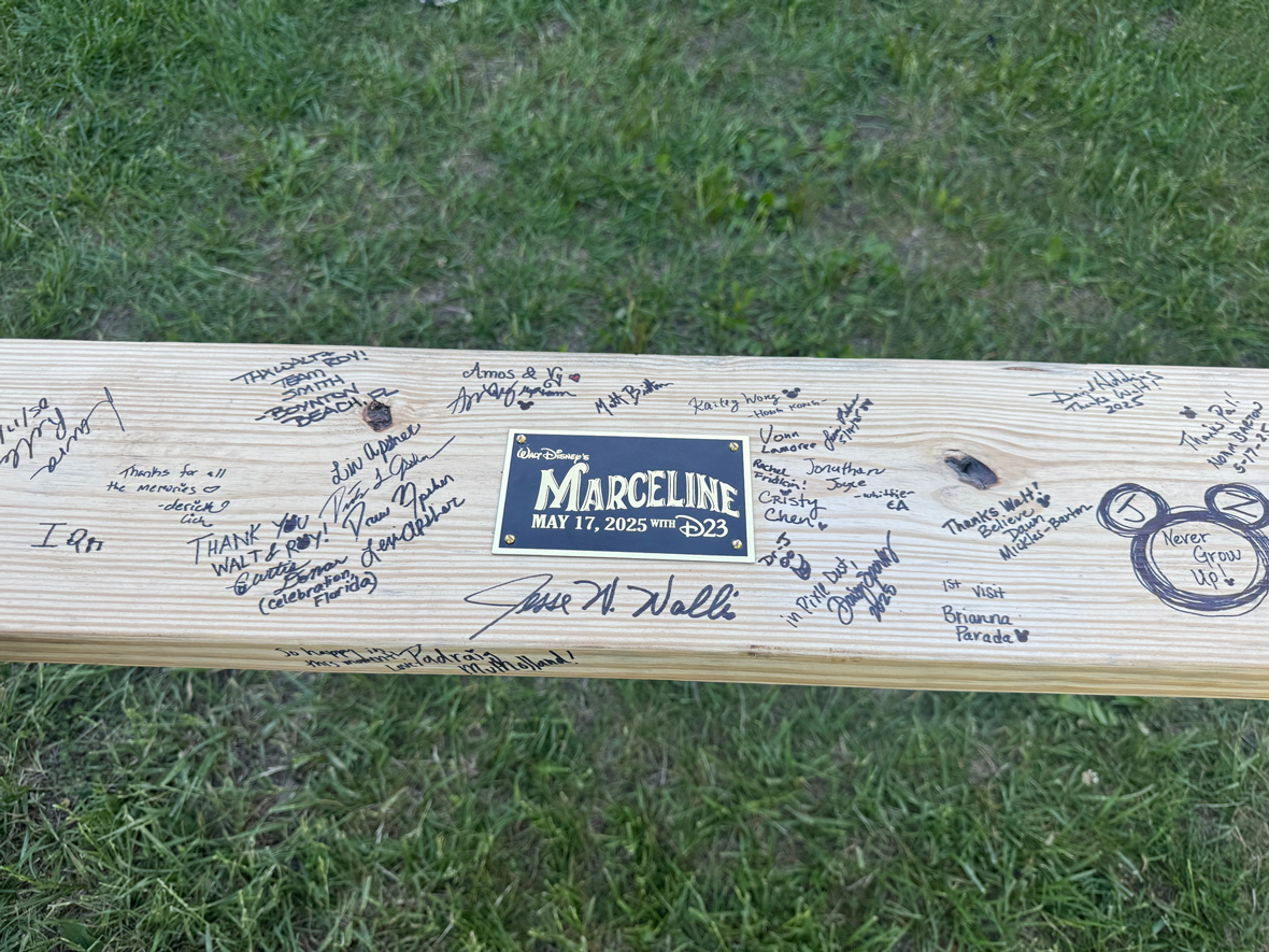 Image from the May 2025 D23 event in Marceline, Missouri, Walt Disney&rsquo;s boyhood home. Guests have signed a piece of wood affixed with a plaque reading &ldquo;Marceline, May 17, 2025, with D23.&rdquo;