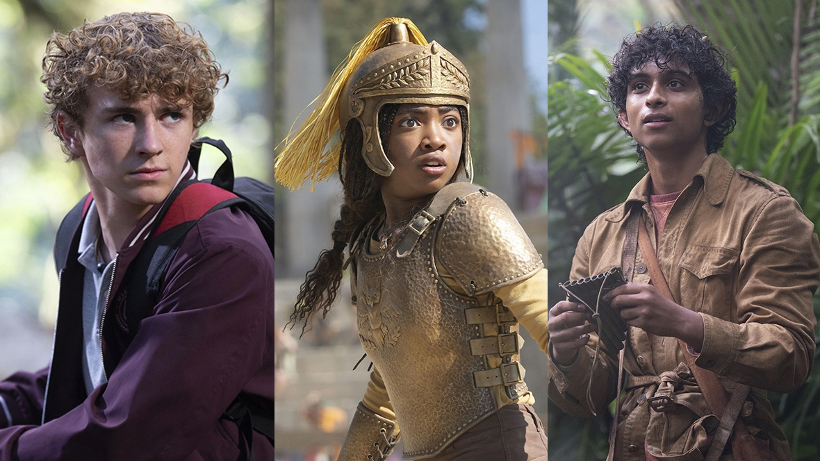 A triptych image of the three stars of Disney+’s Percy Jackson and the Olympians; on the left, Walker Scobell as Percy, in the middle, Aryan Simhadri as Grover; and on the right, Leah Sava Jeffries as Annabeth. Percy is wielding a sword, and is standing in a forest; Annabeth is wearing a helmet and armor and is standing in an arena; Grover is in the jungle and is holding a pan flute.