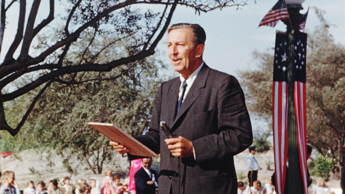 In still from the documentary Disneyland Handcrafted, Walt Disney is seen at a microphone, giving a speech at Disneyland on opening day.