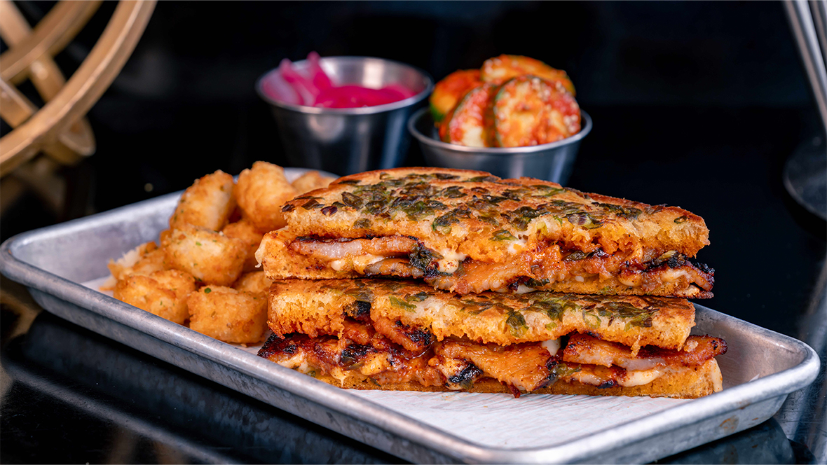 An image of the Spicy Pork Belly Grilled Cheese, available at Pym Test Kitchen during Lunar New Year celebration at Disney California Adventure Park. 
