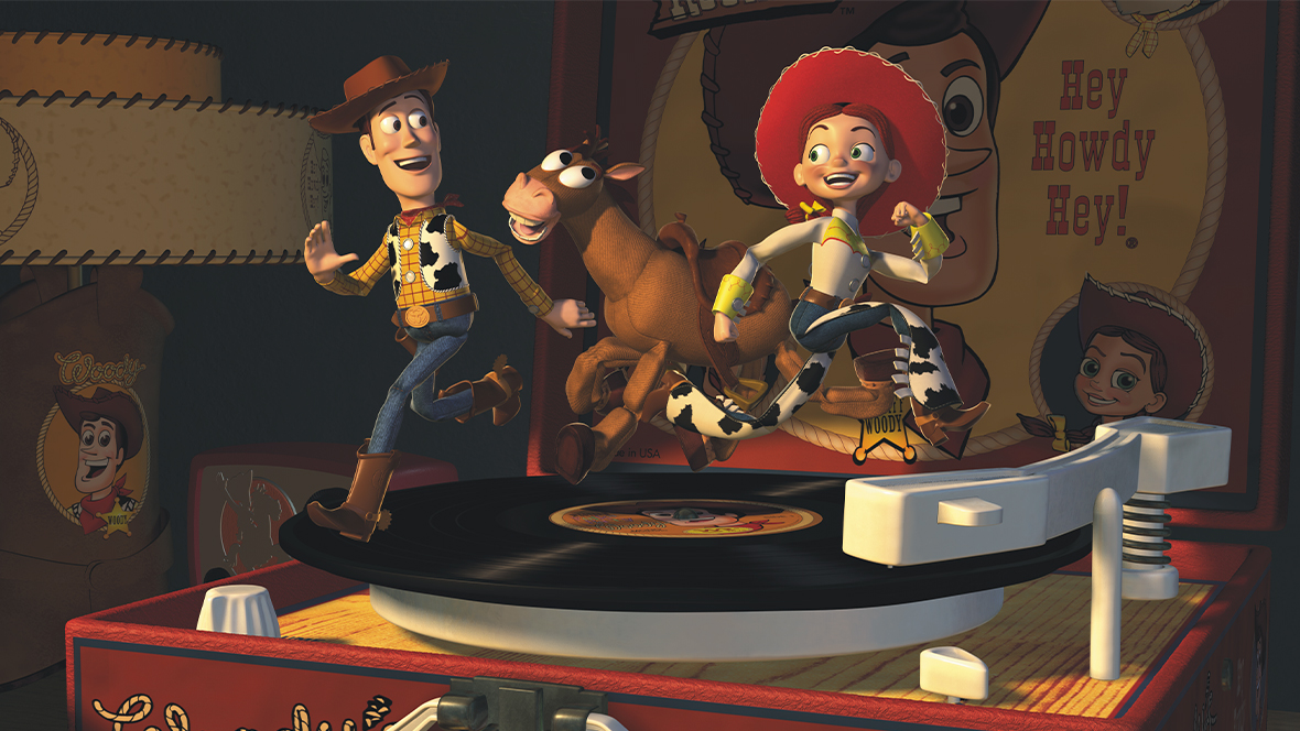 An image of Bullseye alongside Sheriff Woody and Jessie from Disney and Pixar&rsquo;s Toy Story 2. The trio are running on a vinyl record that&rsquo;s playing on a &ldquo;Woody&rsquo;s Round-Up&rdquo; record player. 