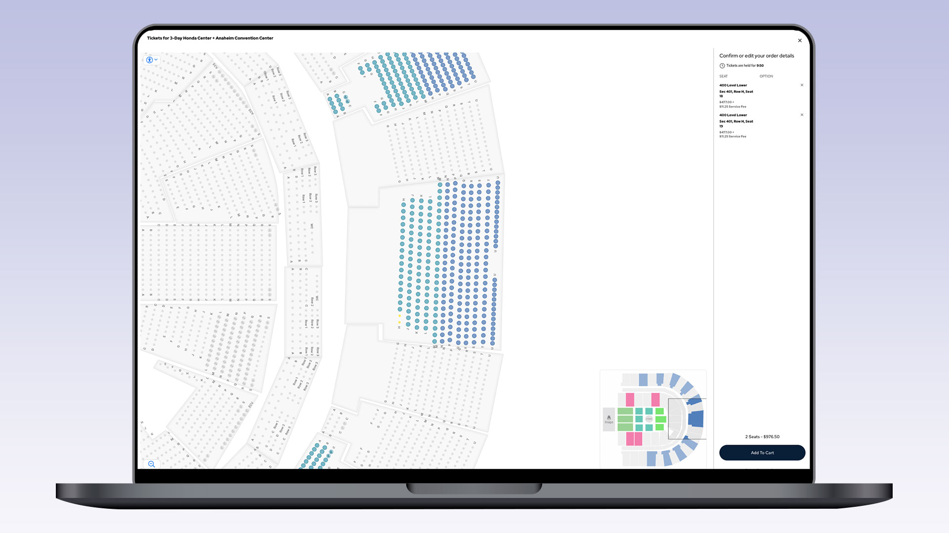 A nearly identical laptop screen to the previous image, showing a seating chart with two selected seats listed on the right panel, and a button to add them to the cart.