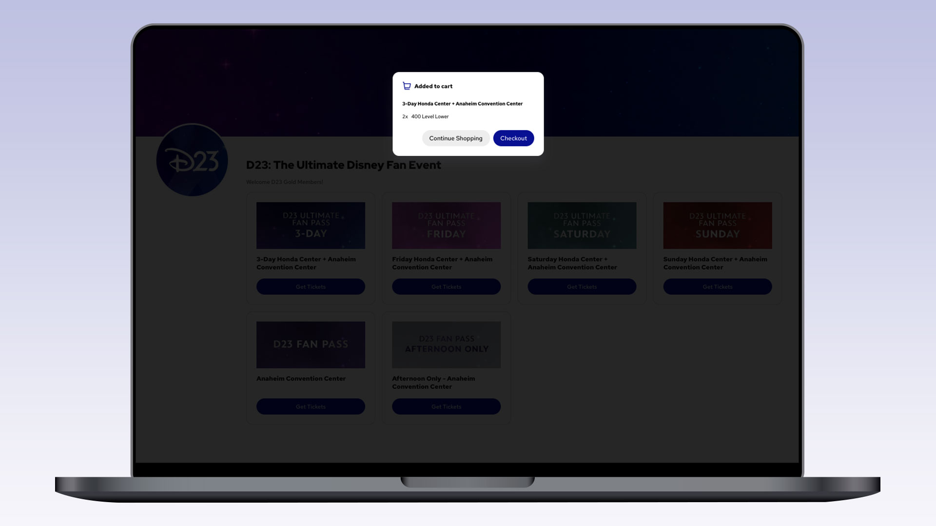 A laptop shows a popup message confirming tickets were added to the cart for the D23 3-Day Honda Center + Anaheim Convention Center event (2x 400 Level Lower seats). The popup offers buttons for "Continue Shopping" and "Checkout" over a blurred background of ticket options.