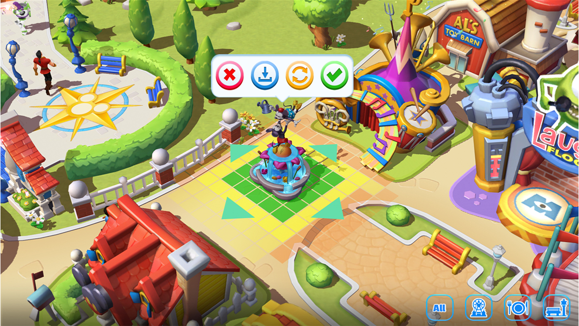Screenshot from Disney Magic Kingdoms showing the park editing mode, with a decorative fountain featuring a cartoon character statue being placed on a grid tile. Arrows around the object indicate placement options, while nearby attractions, pathways, and park decorations are visible in the background.