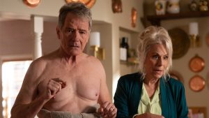 In a scene from Malcolm in the Middle: Life's Still Unfair, Hal, played by Bryan Cranston, is wrapped in a towel. He is standing next to Lois, played by Jane Kaczmarek.