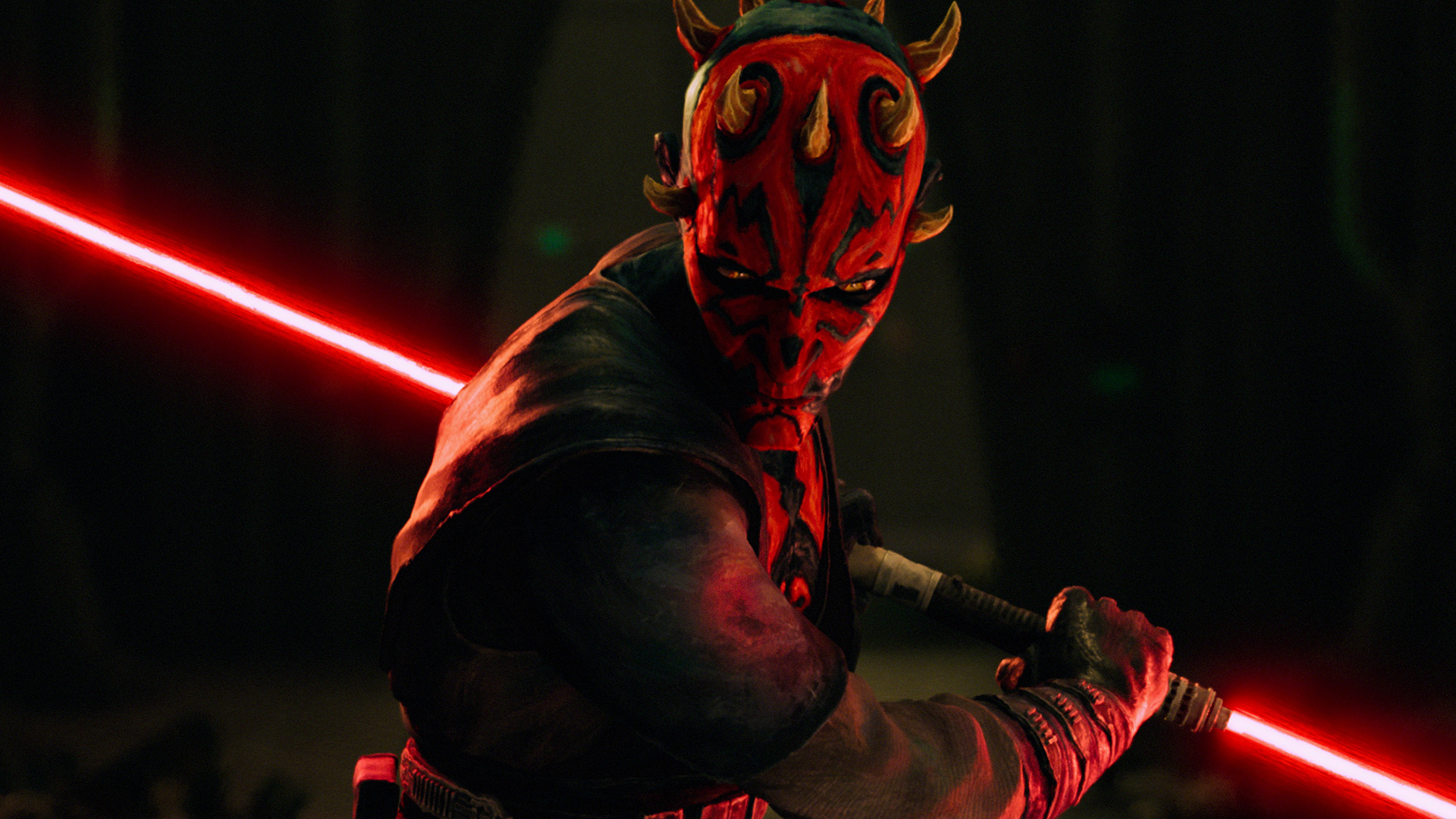 Darth Maul wields his double-bladed red lightsaber in a fighting stance in Star Wars: Maul &ndash; Shadow Lord.