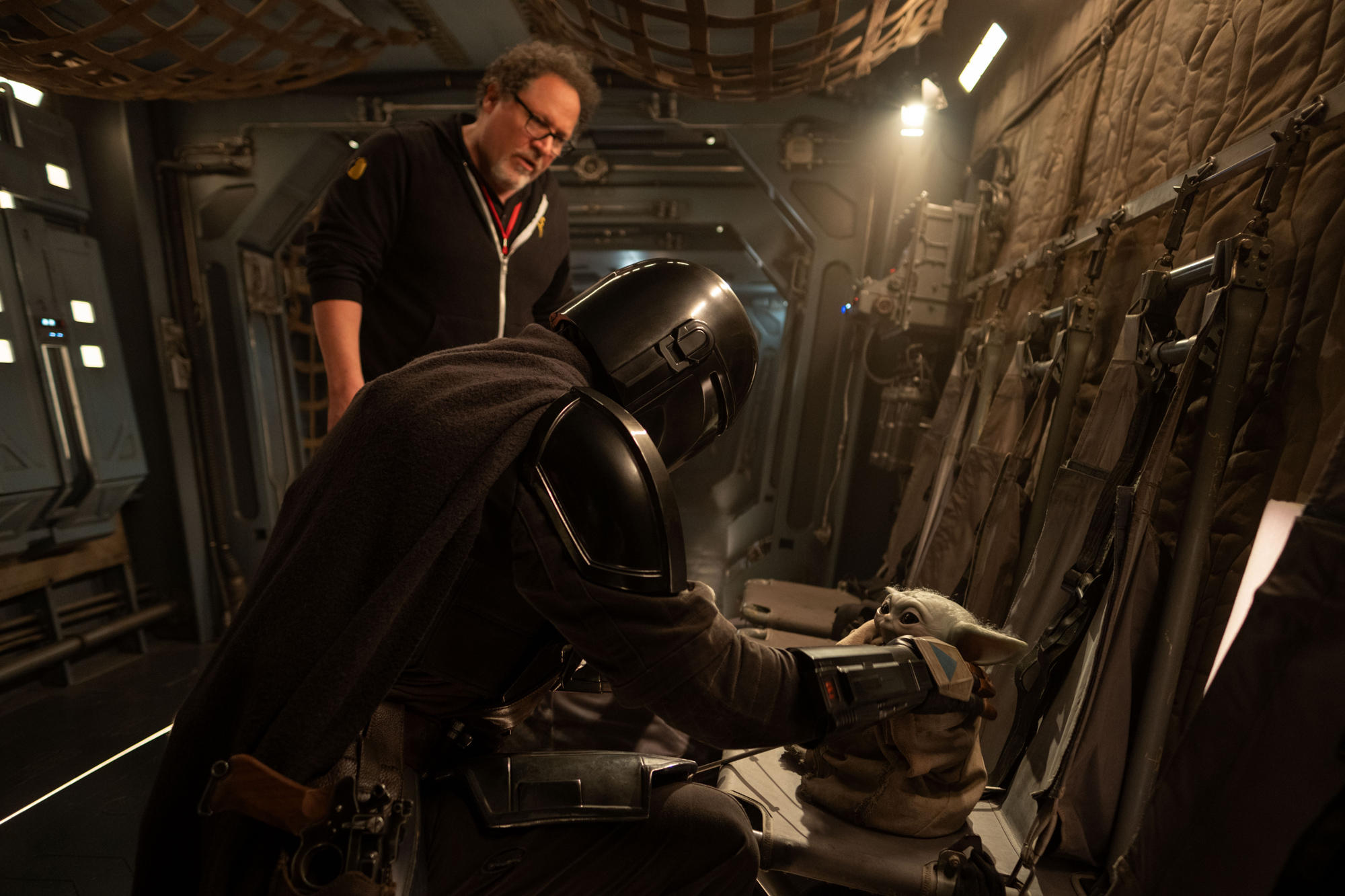 An image of director/co-writer/producer Disney Legend Jon Favreau on the set of Lucasfilm&rsquo;s Star Wars: The Mandalorian and Grogu, with Pedro Pascal as Din Djarin and Grogu.
