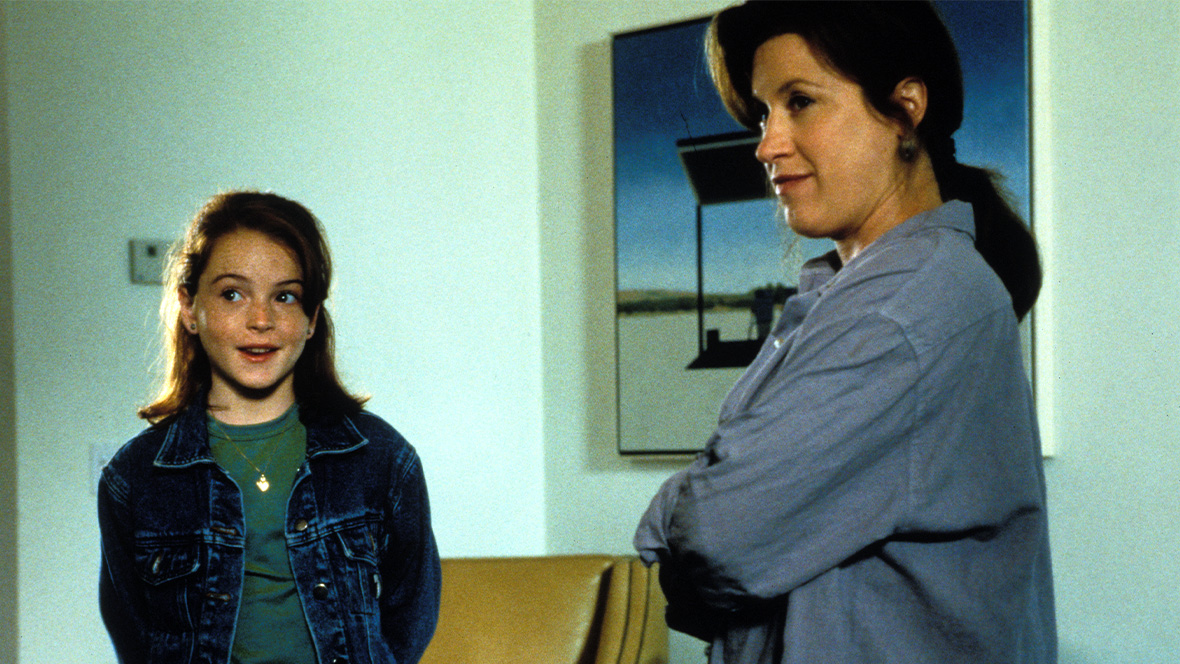In an image from 1998&rsquo;s The Parent Trap, &ldquo;Hallie&rdquo; (Lindsay Lohan), left, and Chessy (Lisa Ann Walter), right, stand next to each other and look at something off camera to the left.
