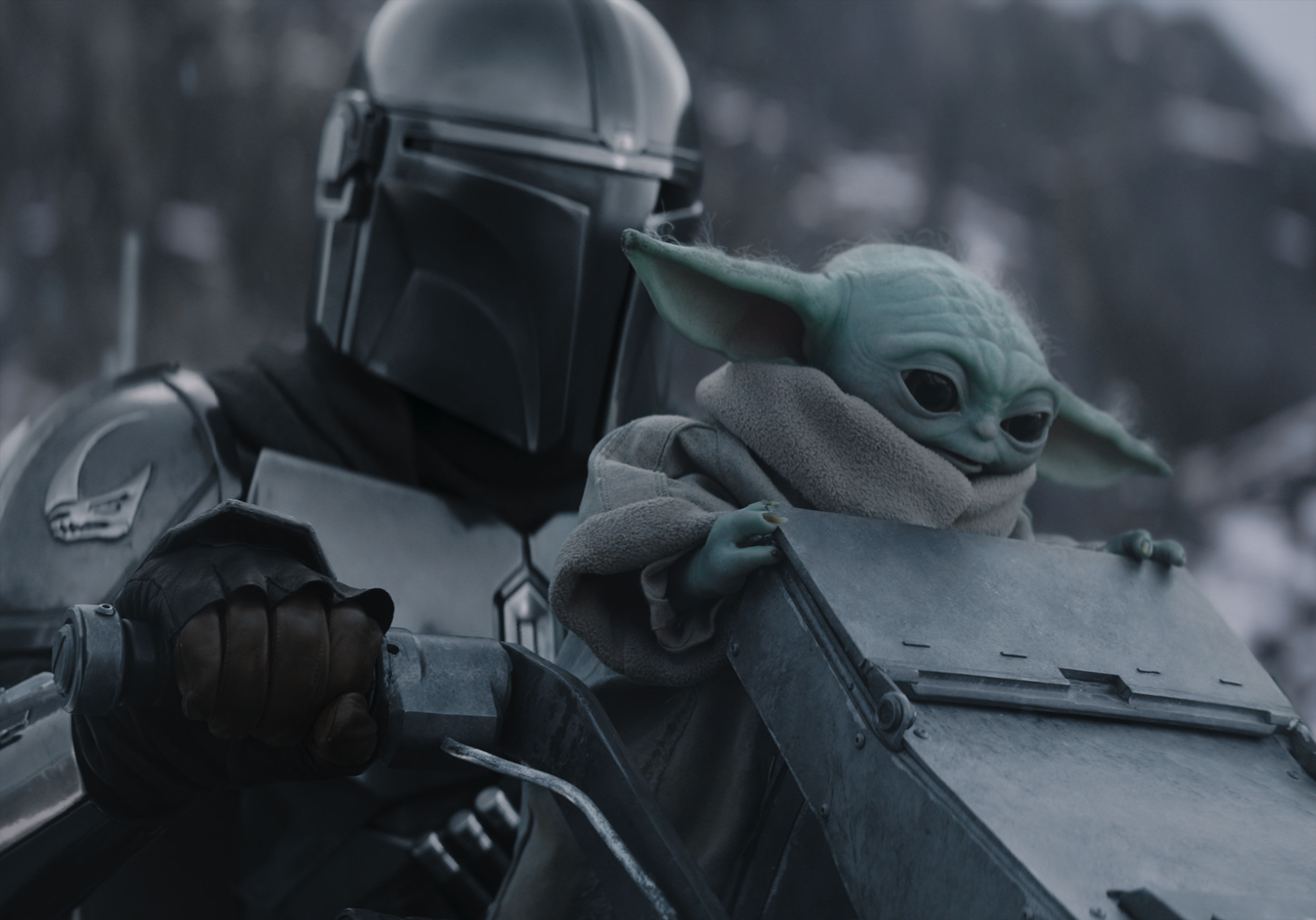 An image from Lucasfilm&rsquo;s Star Wars: The Mandalorian and Grogu featuring Grogu and Din Djarin (Pedro Pascal) on the back of a cycle-style vehicle.