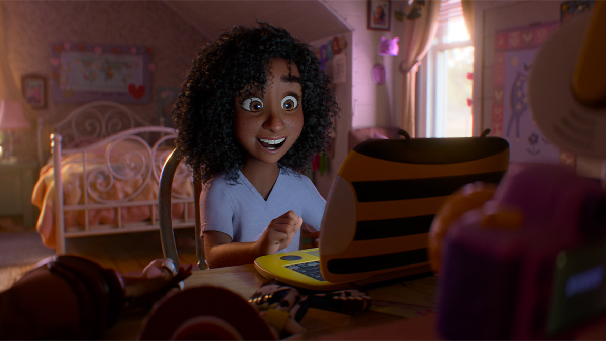 In an image from Disney and Pixar&rsquo;s Toy Story 5, Blaze (voiced by Mykal-Michelle Harris) is sitting at her bedroom desk, in front of a laptop computer; she has a wide smile on her face.