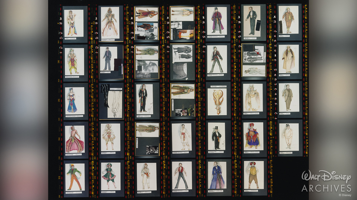 A contact sheet from Moulin Rouge! featuring dozens of costume sketches arranged in rows and columns. The designs include evening wear, dramatic outerwear, and stage costumes, with some costume swatches attached.
