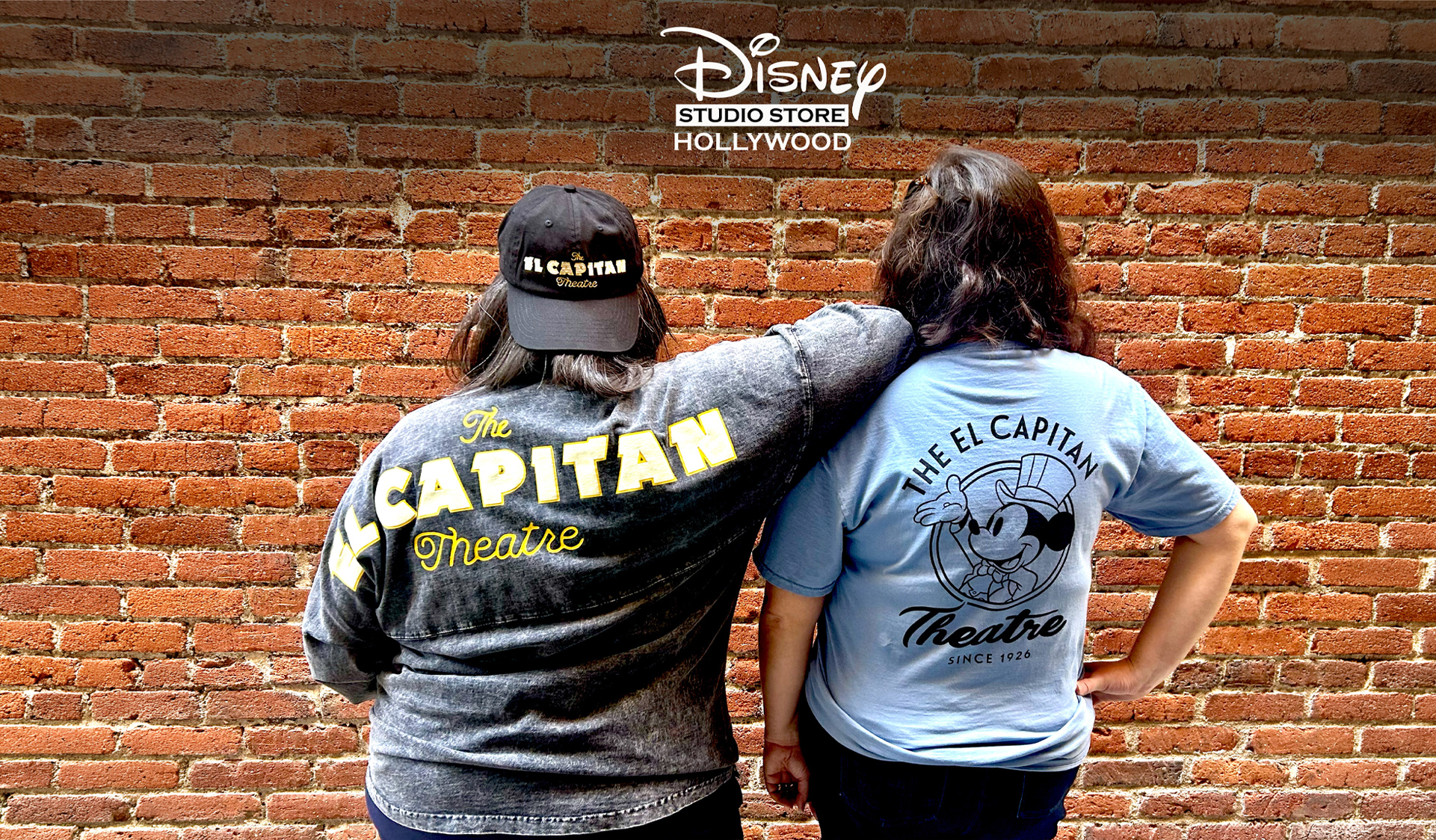 An image of the back of two people wearing items that will be available at Disney Studio Store Hollywood&mdash;one of the stores at D23: The Ultimate Disney Fan Event 2026.