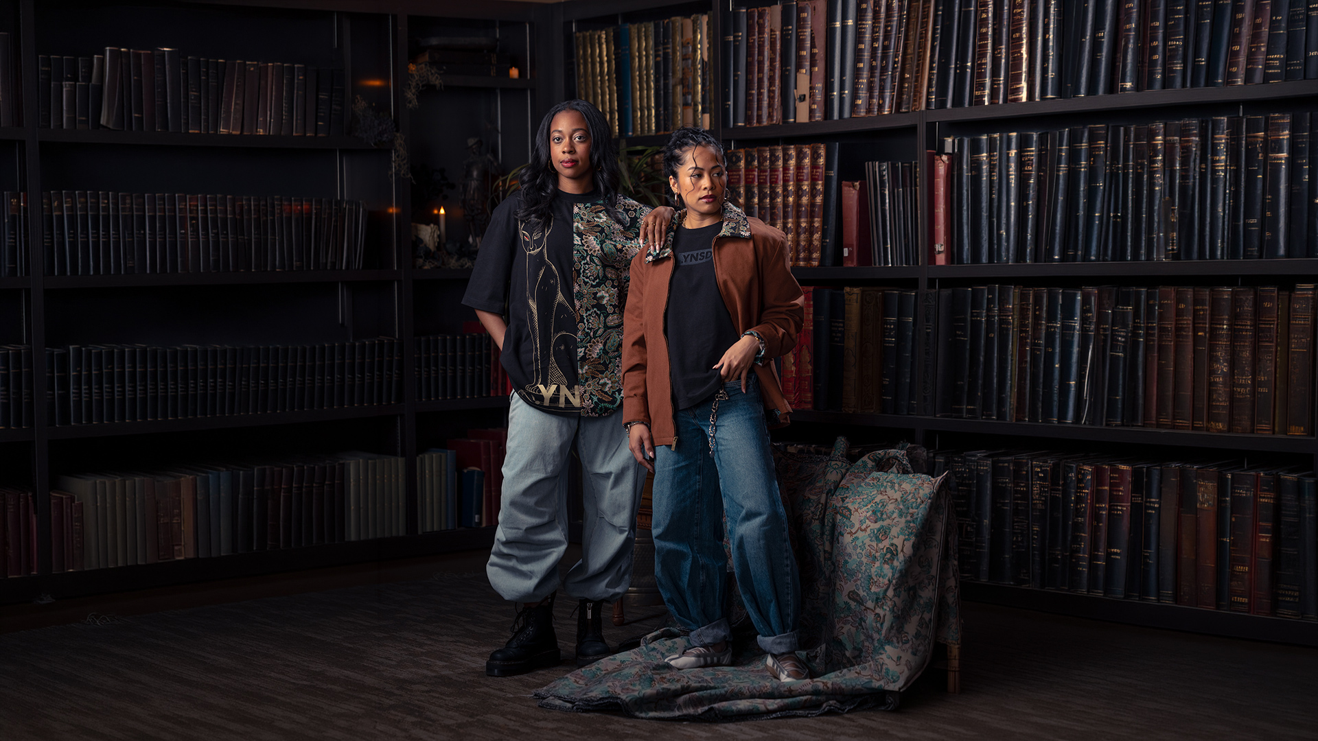 An image of two people wearing clothing from the Disney .YNSD collection, which can be found during D23: The Ultimate Disney Fan Event 2026.