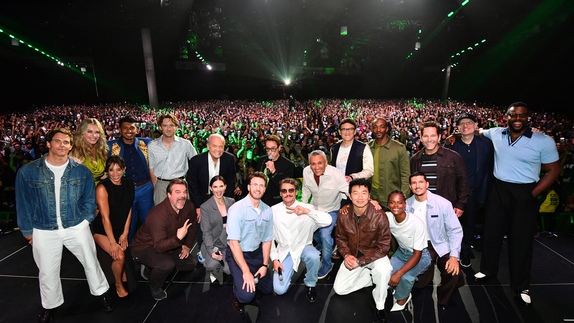 From left to right, James Marsden, Rebecca Romijn, Hannah John-Kamen, Tenoch Huerta, Lewis Pullman, David Harbour, Kelsey Grammer, Hayley Atwell, Chris Evans, Disney Legend Robert Downey Jr., Pedro Pascal, Joe Russo, Anthony Russo, Simu Liu, Anthony Mackie, Letitia Wright, Danny Ramirez, Paul Rudd, Kevin Feige, and Winston Duke pose onstage during the Marvel Studios Panel at San Diego Comic-Con on July 25, 2026.
