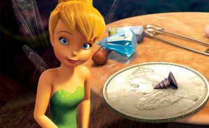 Tinker Bell standing beside oversized everyday objects, including a coin, gemstone, nut, safety pin, and bracelet.