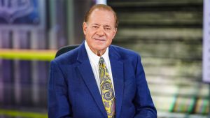 Disney Legend Chris Berman sits at the anchor desk.
