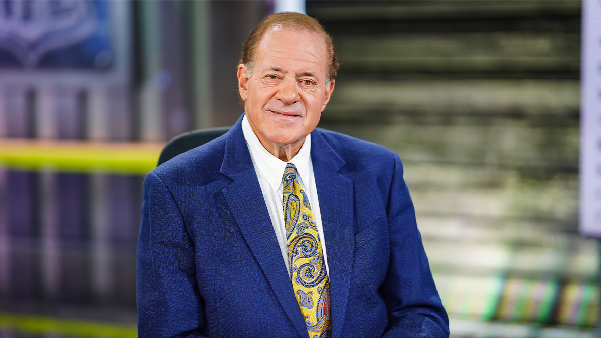 Disney Legend Chris Berman sits at the anchor desk.