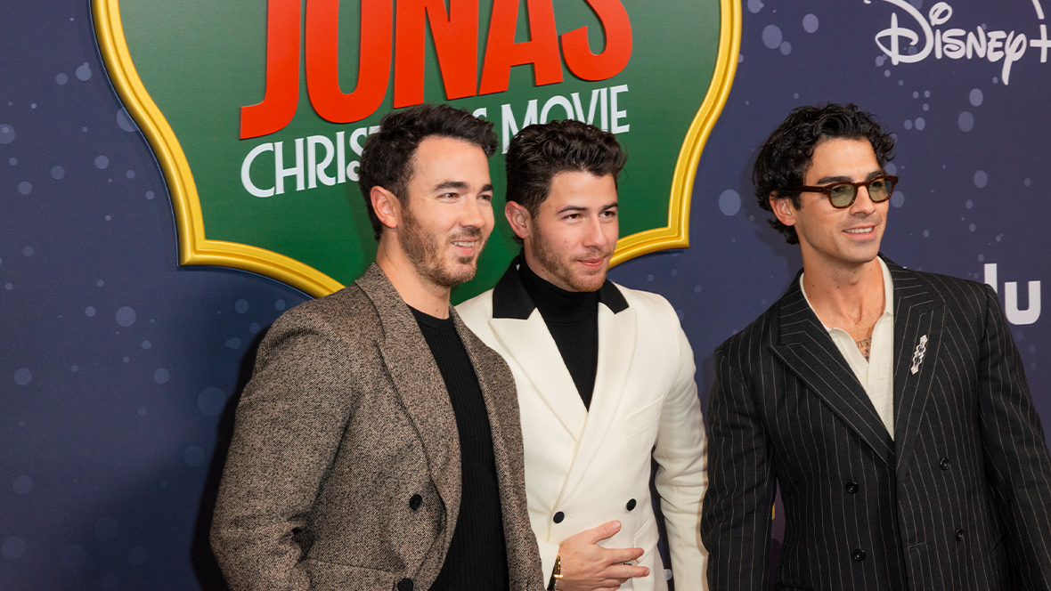 Disney Legends Kevin Jonas, Nick Jonas, and Joe Jonas pose on the red carpet at the world premiere of A Very Jonas Christmas Movie in New York City.