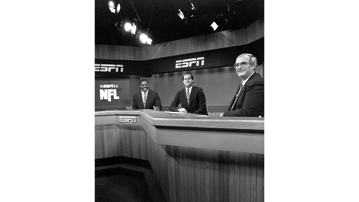 Disney Legend Chris Berman sits at the ESPN Gameday anchor desk in 1987.