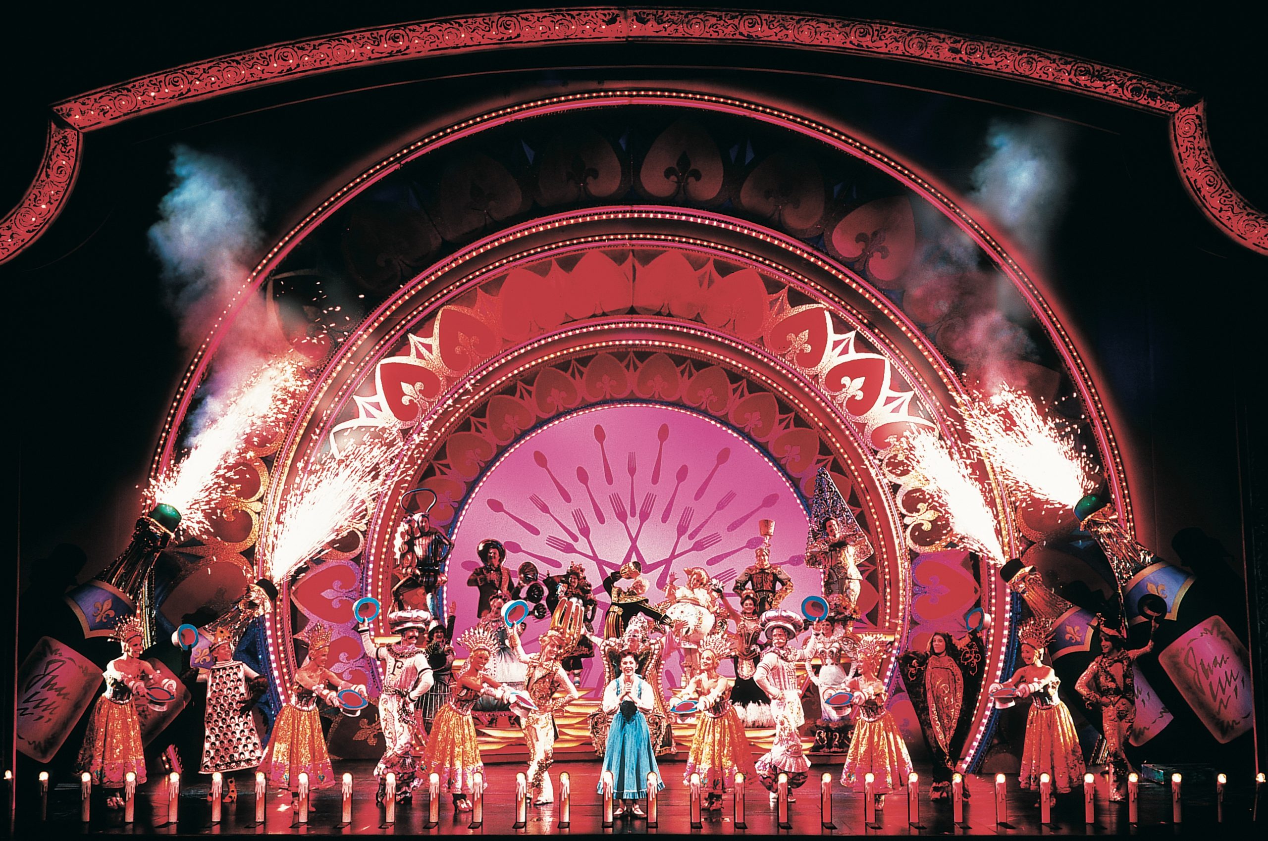 Disney Legend Susan Egan performs as Belle in "Be Our Guest," part of Beauty and the Beast on Broadway. She is surrounded by dancers dressed as dishes and silverware.