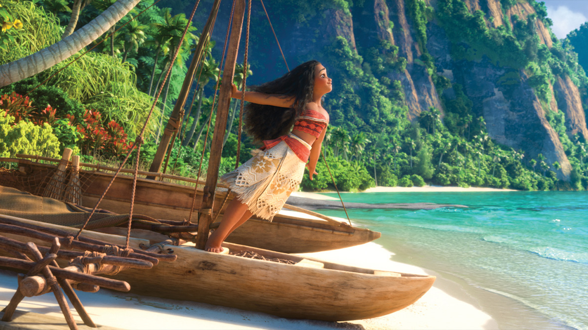 Moana leans forward on her canoe and faces the ocean in Disney's Moana.