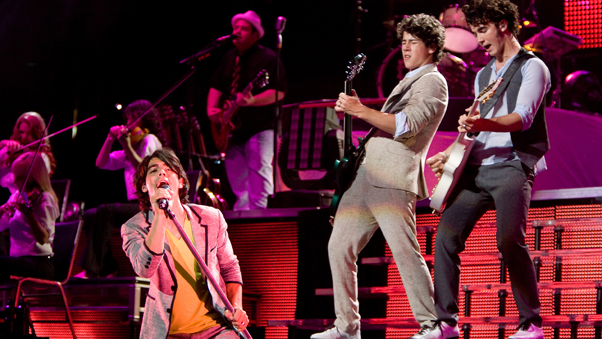 Disney Legends Joe Jonas, Nick Jonas, and Kevin Jonas perform onstage at Madison Square Garden while taping Jonas Brothers: The 3D Concert Experience.