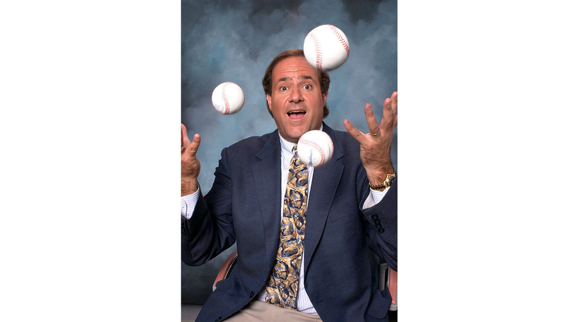 Disney Legend Chris Berman juggles three baseballs.