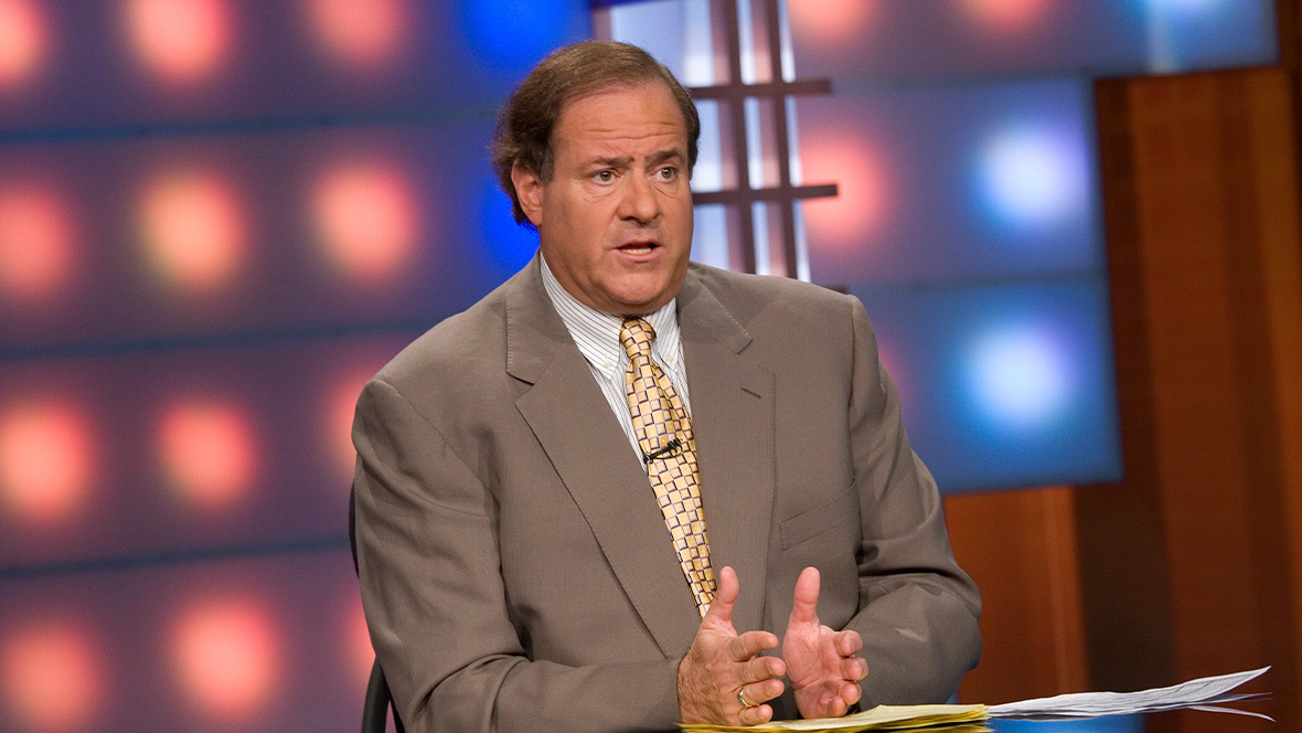 Disney Legend Chris Berman sits at the anchor desk.