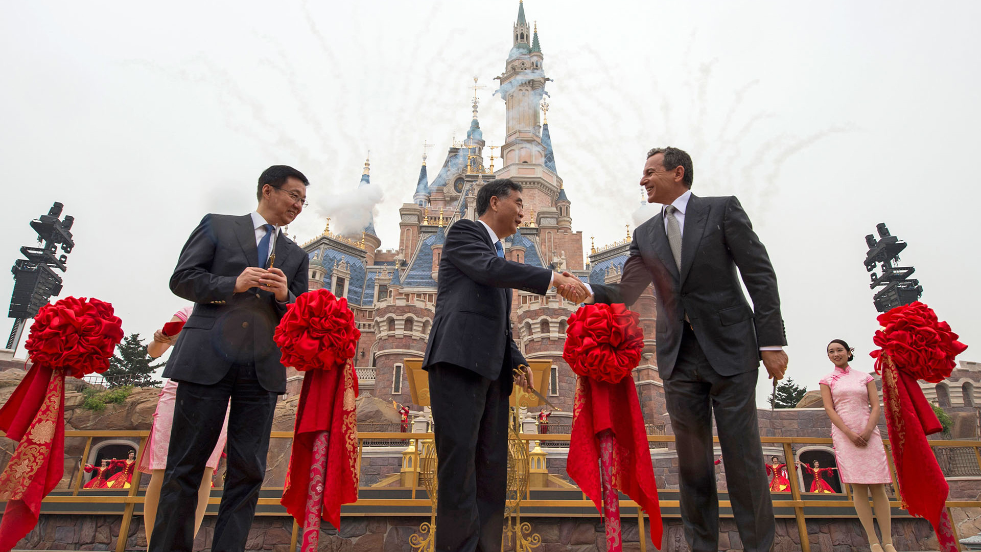 Bob Iger participates in a ceremonial ribbon-cutting moment in front of Enchanted Storybook Castle during the Shanghai Disney Resort opening celebration.