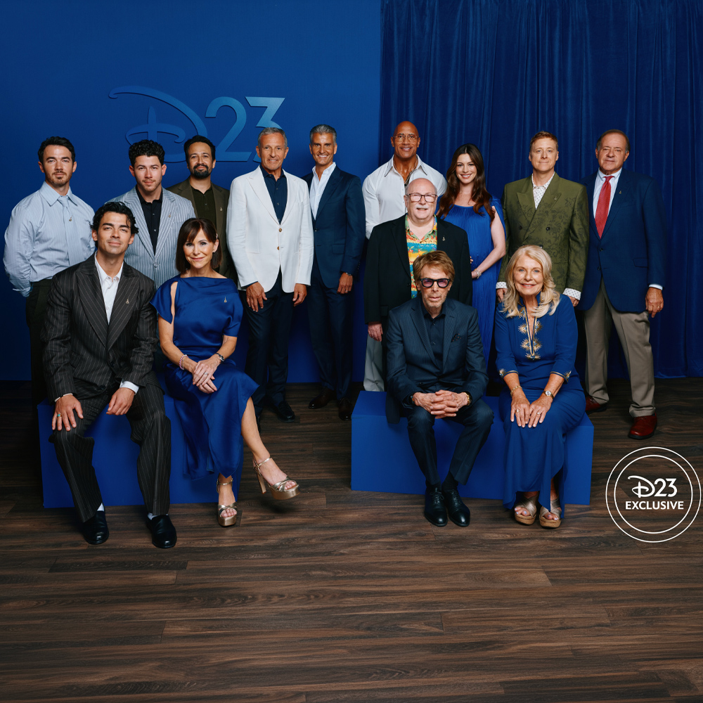 Members of the 2026 Disney Legends class pose together for a group portrait at a D23 event ceremony.