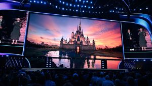 An image of Ginnifer Goodwin and Ke Huy Quan on stage at the Honda Center during the Disney Entertainment Showcase at D23: The Ultimate Disney Fan Event 2026.