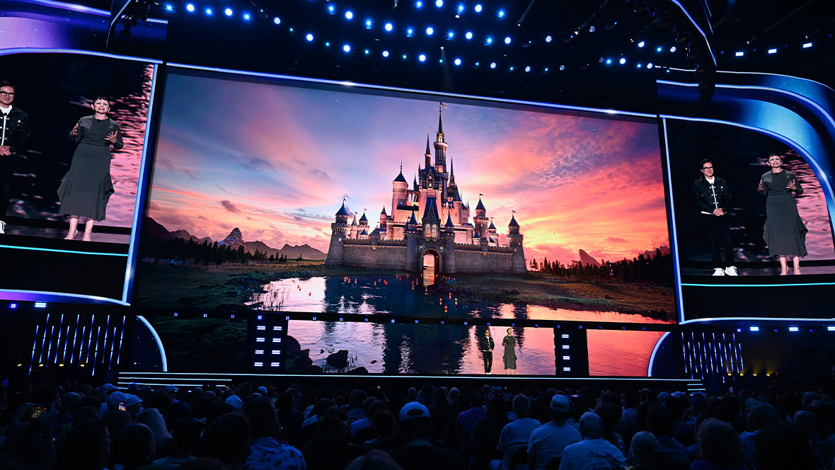 An image of Ginnifer Goodwin and Ke Huy Quan on stage at the Honda Center during the Disney Entertainment Showcase at D23: The Ultimate Disney Fan Event 2026.