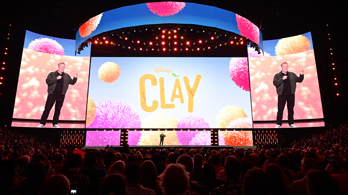 An image of Walt Disney Animation Studios Chief Creative Officer Jared Bush, on stage at the Honda Center during the Disney Entertainment Showcase at D23: The Ultimate Disney Fan Event announcing the upcoming film Clay.