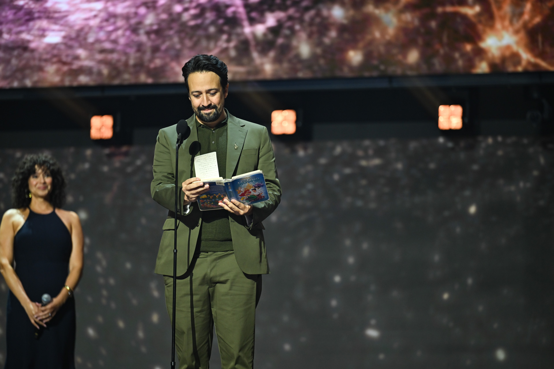 Lin-Manuel Miranda speaks onstage during the 2026 Disney Legends Awards ceremony while presenting a tribute.