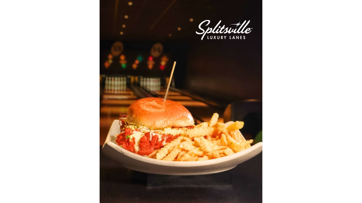 A sandwich with fries sits in front of bowling lanes during the Hulu Animayhem promotion at Splitsville Luxury Lanes.