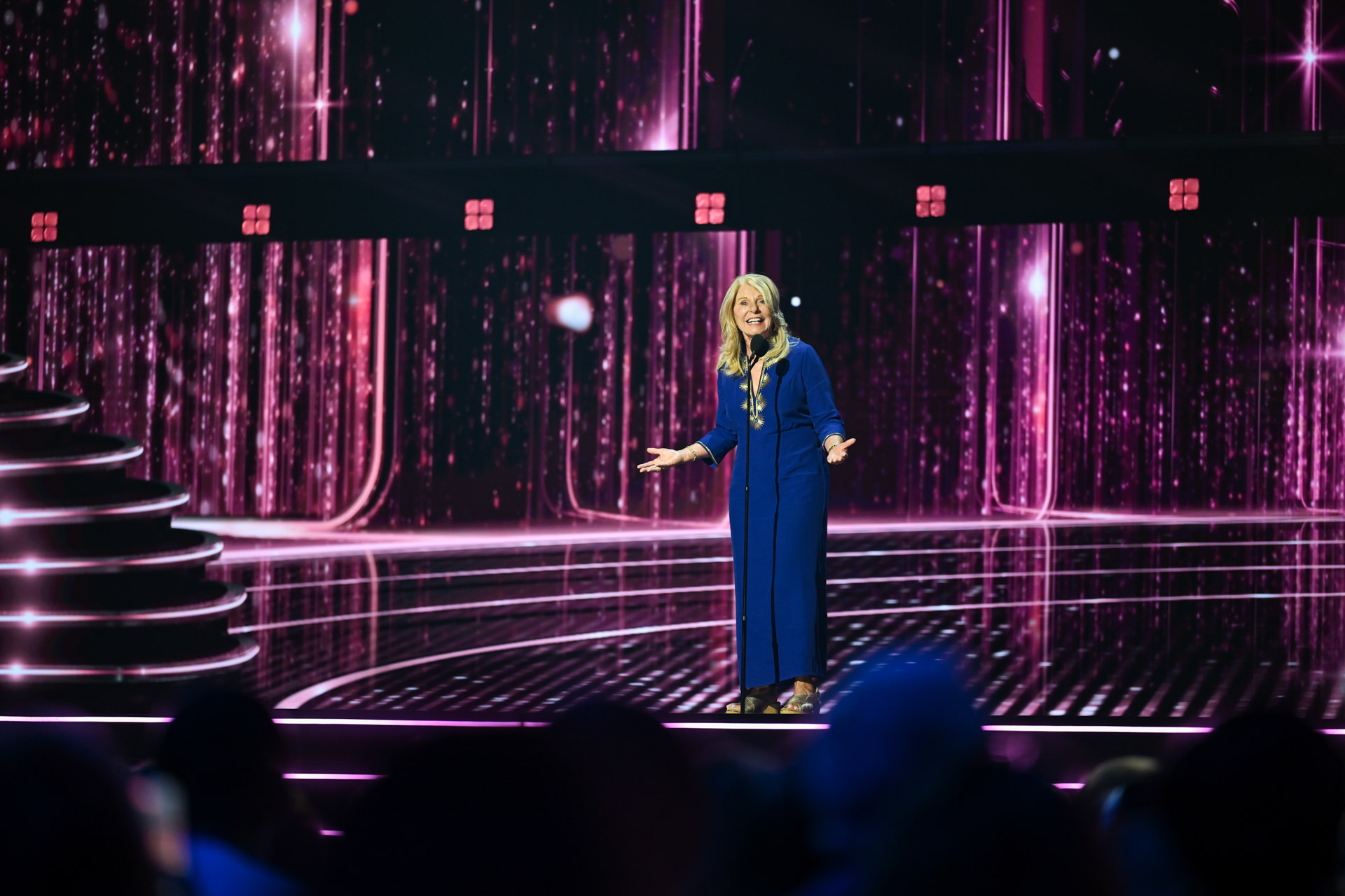Kim Irvine addresses the audience onstage during the 2026 Disney Legends Awards ceremony.