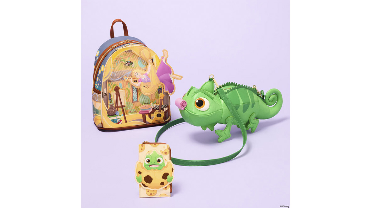 Three Disney Tangled-inspired accessories are displayed against a light purple background. A mini backpack features artwork of Rapunzel inside her tower surrounded by painting supplies, a guitar, and her long golden hair. Beside it is a green crossbody bag shaped like Pascal the chameleon, complete with large eyes and textured details. In front is a small matching accessory showing Pascal wrapped like a burrito in a tortilla-themed design. The collection uses soft pastel colors and playful character-inspired styling.