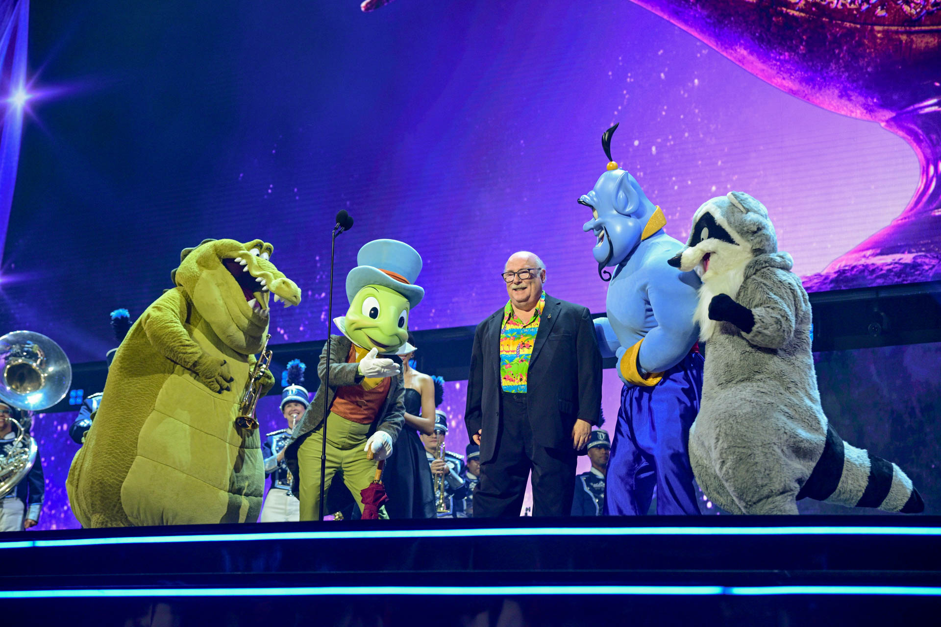 Eric Goldberg stands beside Disney characters during his Disney Legends recognition at the 2026 Disney Legends Awards ceremony.
